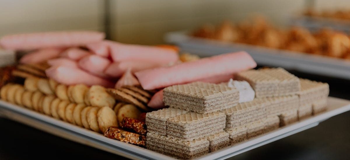 A close-up of a tray with an assortment of wafers and snacks, ideal for gatherings.