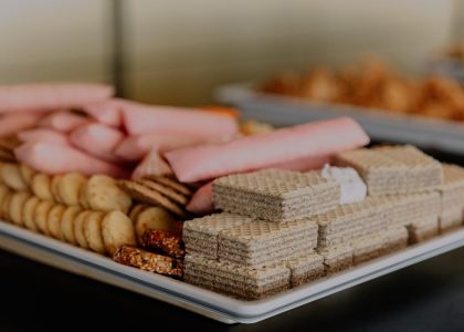 A close-up of a tray with an assortment of wafers and snacks, ideal for gatherings.